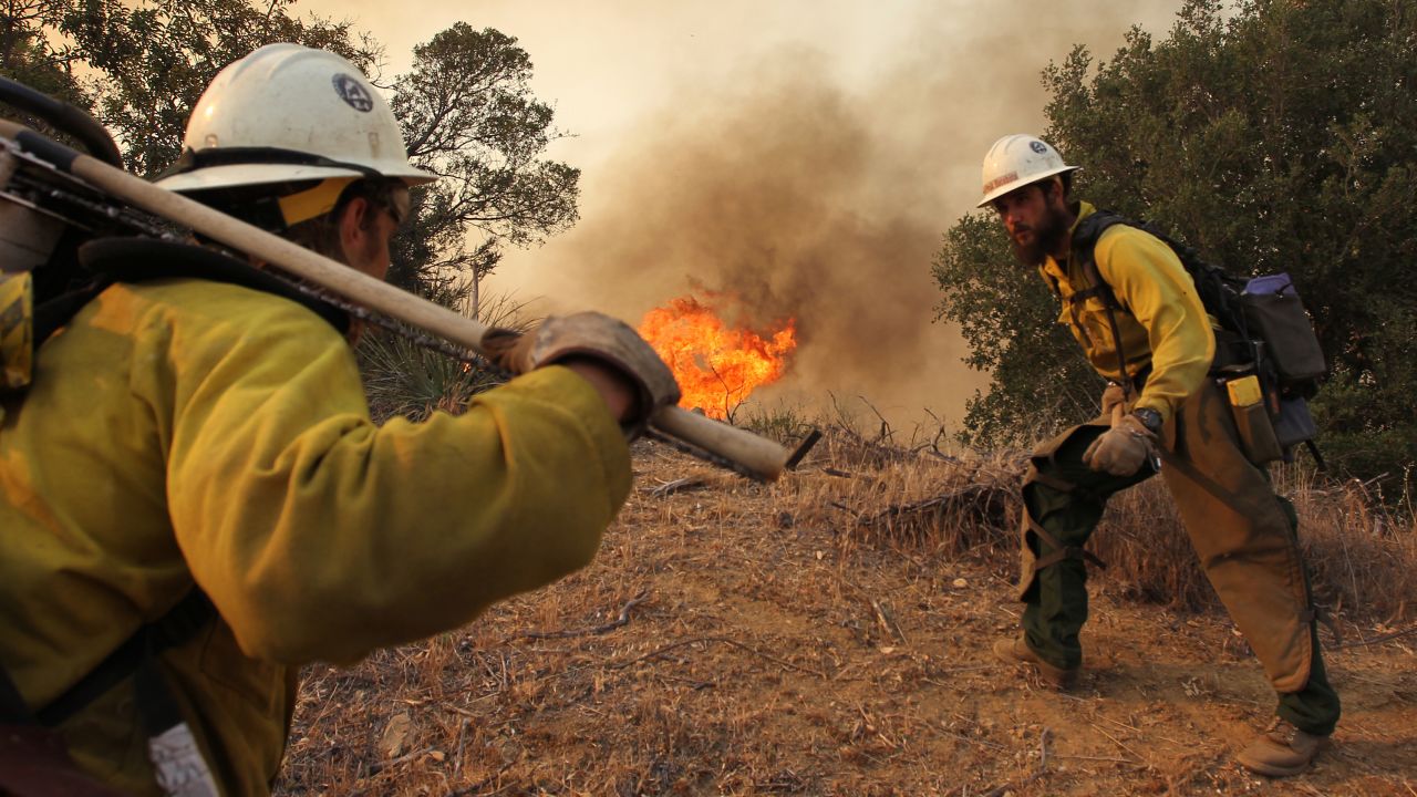 Firefighters based out of the Lone Peak Conservation Center in Draper, Utah, build a fire break as a wildfire continues to grow on May 3, near Camarillo, California.