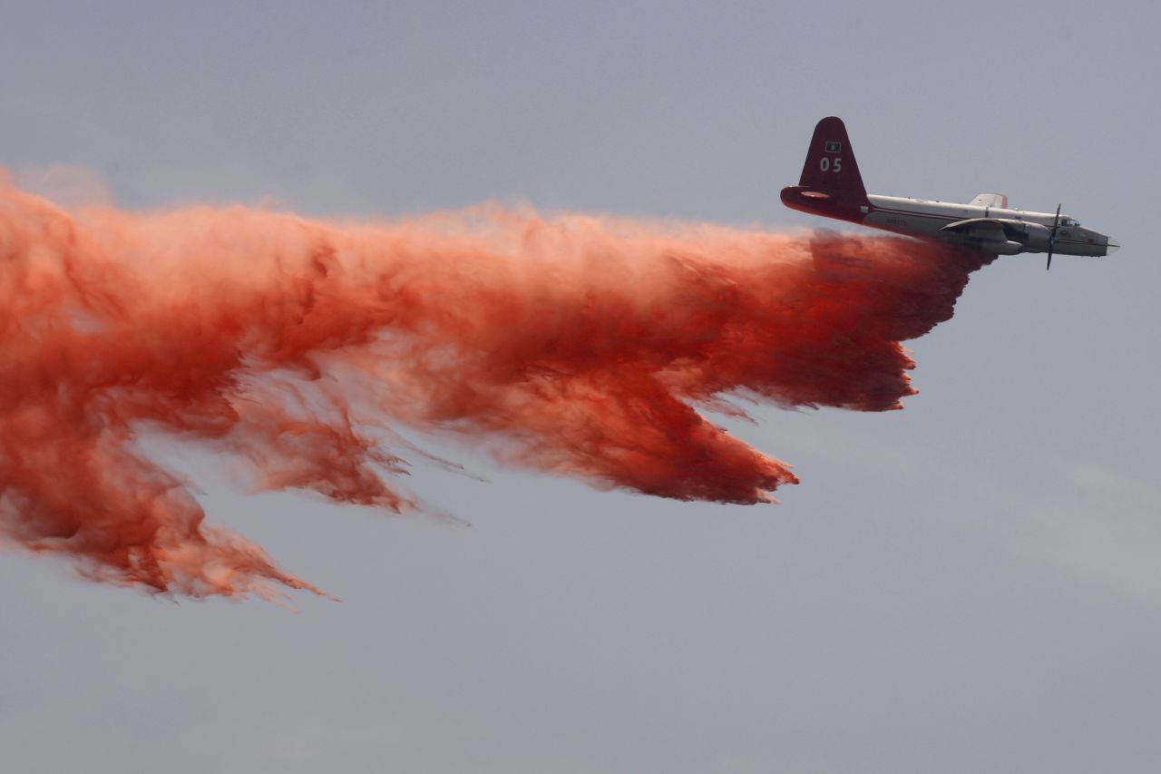 A tanker plane drops fire retardant to control the Springs Fire in Camarillo on Saturday, May 4. 