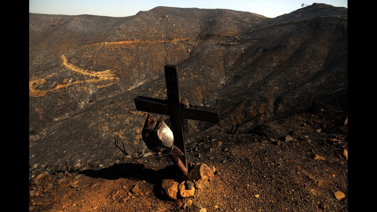 A burned cross stands along the side of a road amid scorched mountains burned by the Springs Fire near Point Mugu State Park, 40 miles north of Los Angeles, on May 4.