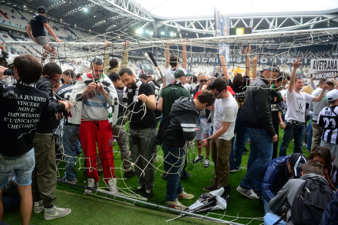 The Turin side's fans invaded the pitch at the Alps stadium after the match to get mementos of Juventus' success. 