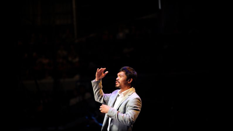 Pacquiao gestures during a prayer rally at the Araneta Coliseum in Manila on July 28, 2012. The prayer rally was a way for Pacquiao to thank his fans and supporters for the blessings he received.