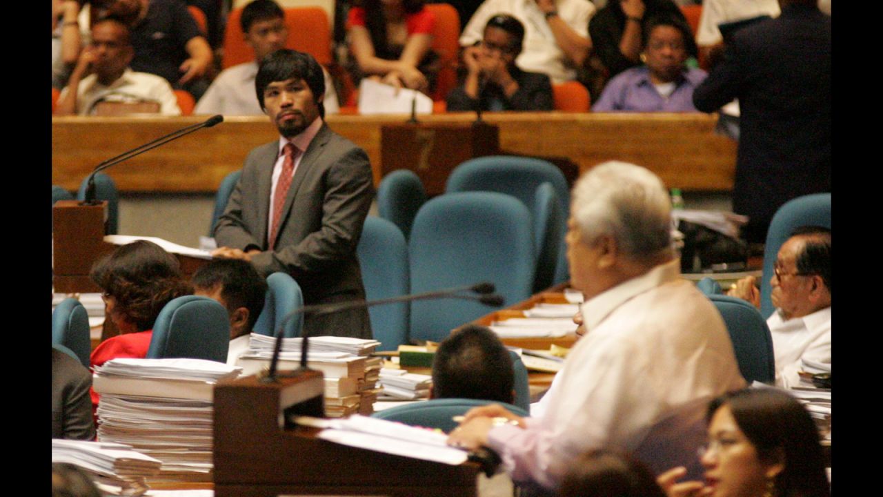 Pacquiao looks toward Congressman Edcel Lagman, right, at the House of Representatives on May 18, 2011.