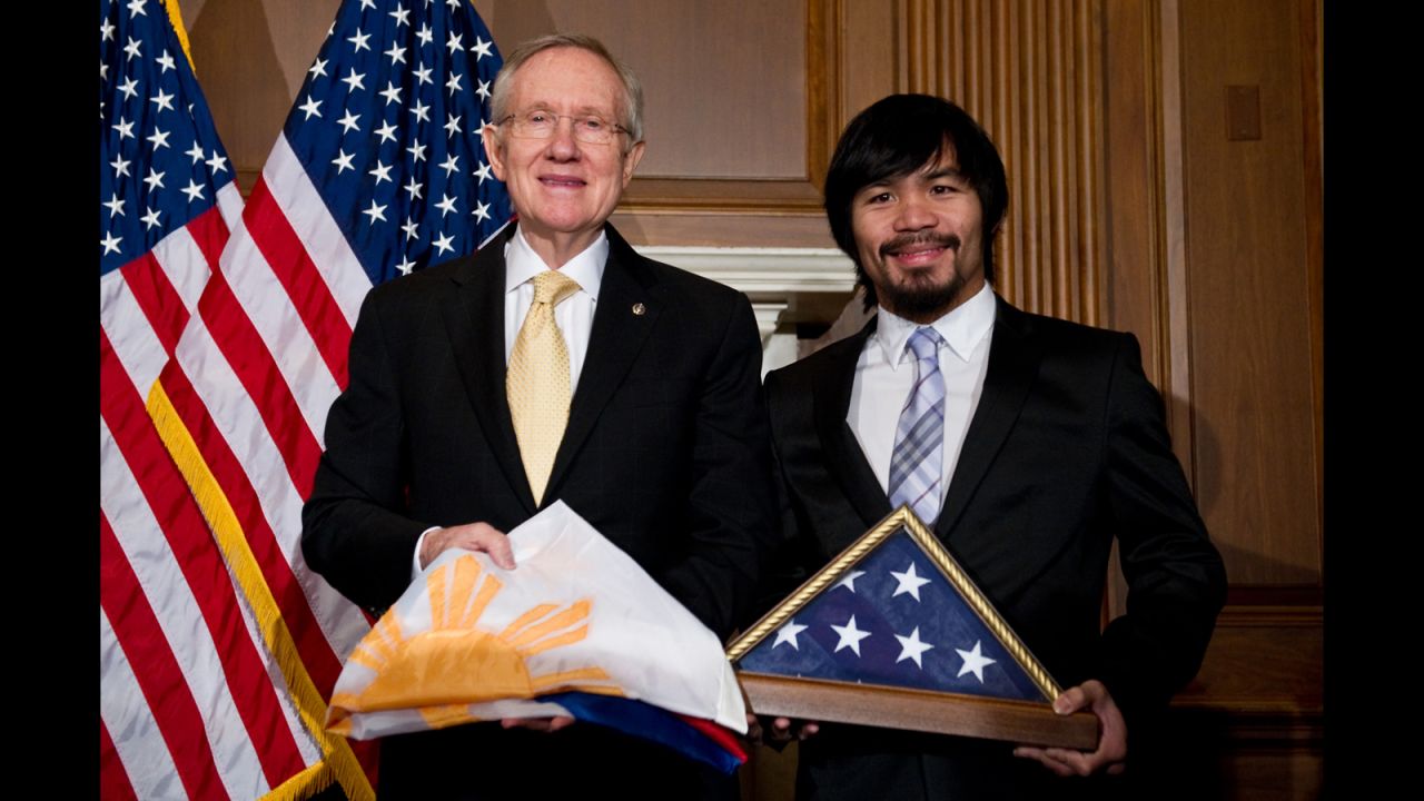 Pacquiao and U.S. Senate Majority Leader Harry Reid exchange flags in Washington on February 15, 2011.