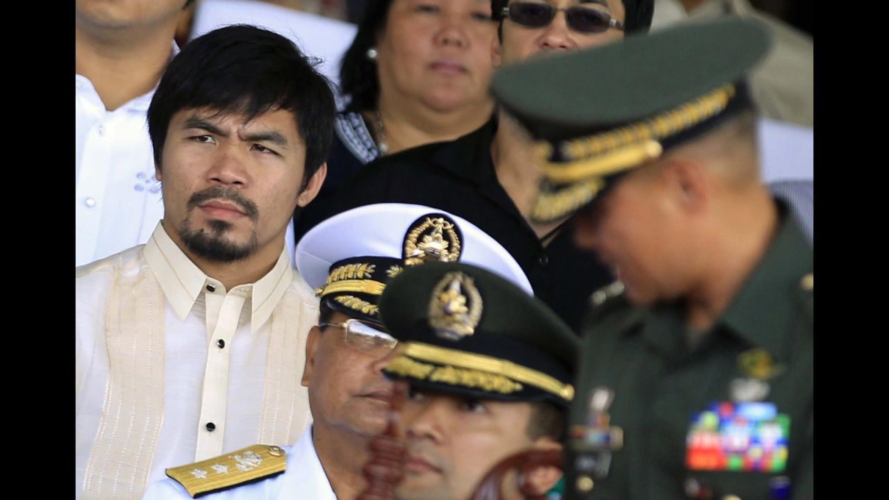 Pacquiao listens during the turnover ceremony for the new commanding general of the Philippine army at Fort Bonifacio on July 23, 2010. 