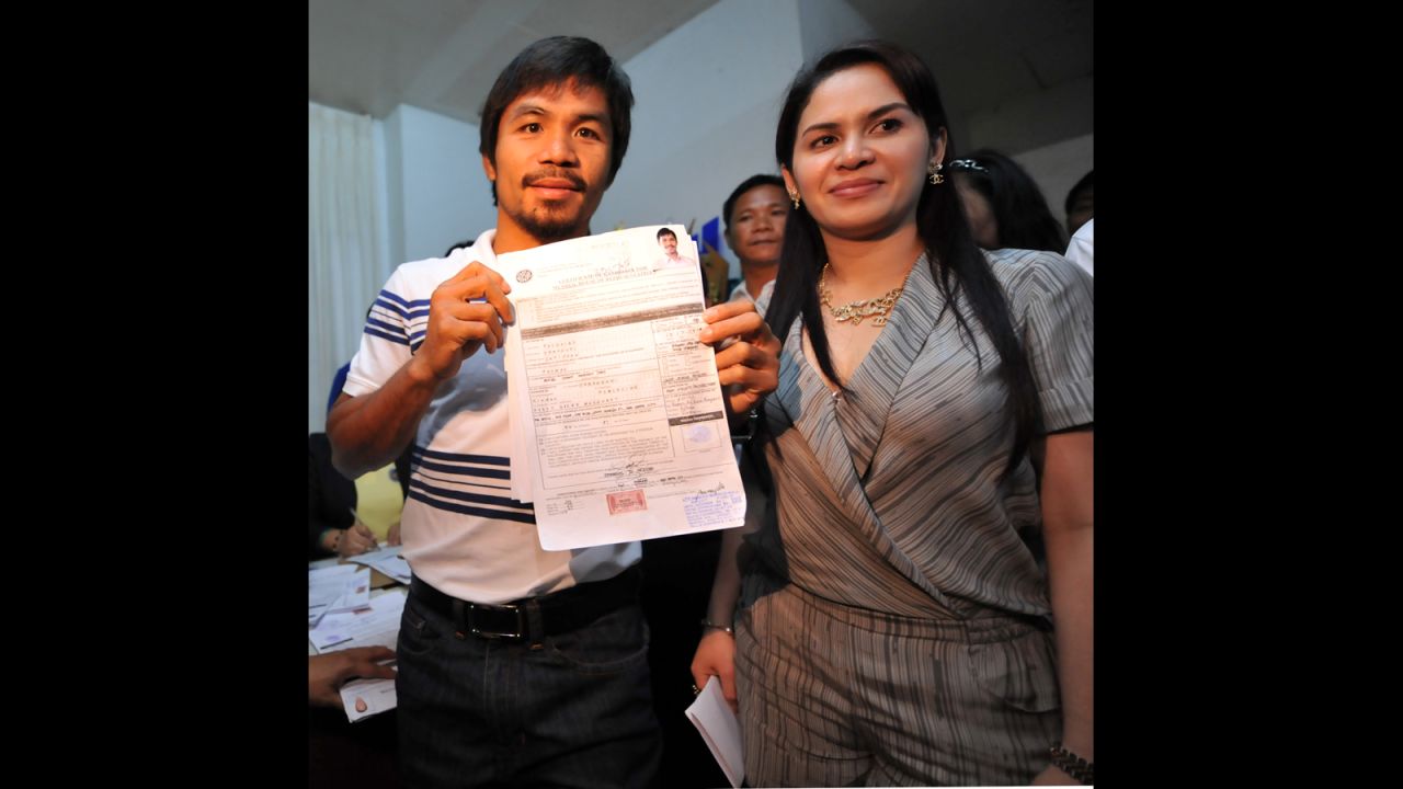 Pacquiao poses with his certificate of candidacy next to his wife, Jinkee, after filing in the town of Alabel, Saragani province, on December 1, 2009. 