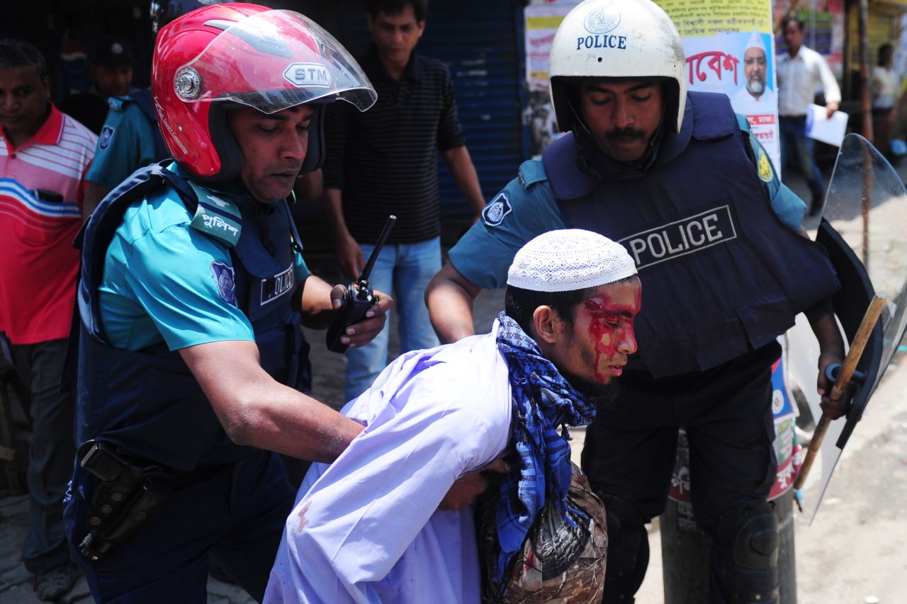 Bangladeshi police detain a protester on May 5.