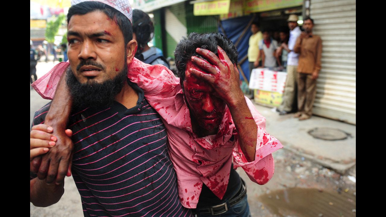 Civilians carry an injured protester on May 5.