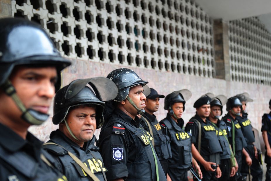 Rapid Action Battalion personnel stand guard following a clash between police and Islamists in Dhaka on May 6.