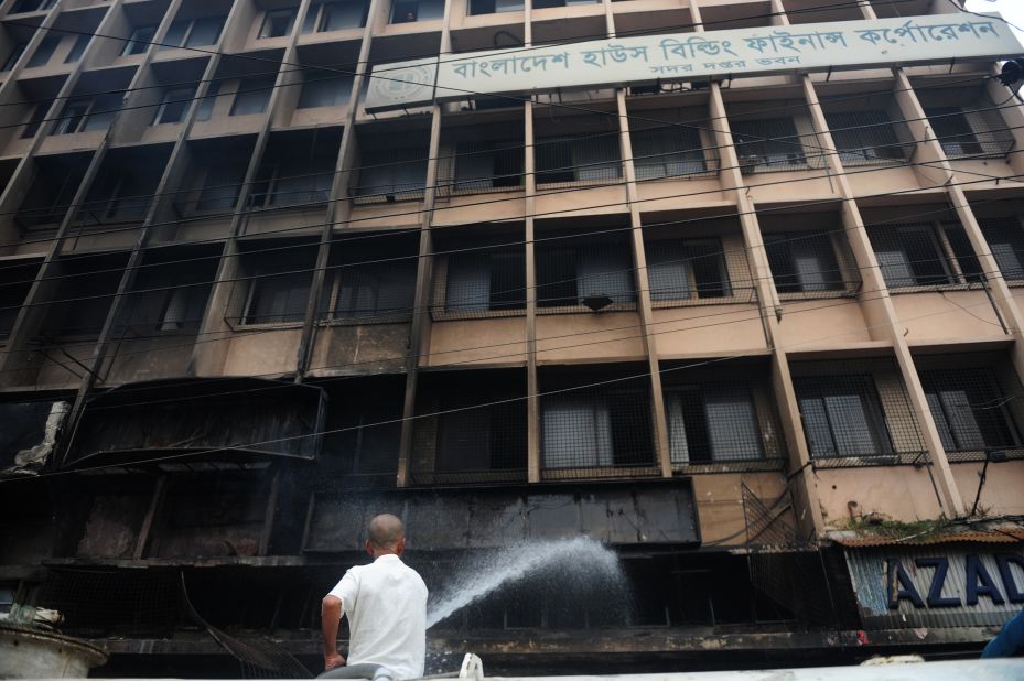 A Bangladeshi man extinguishes a blaze at a building near the national mosque Baitul Mukarram in Dhaka on May 6.