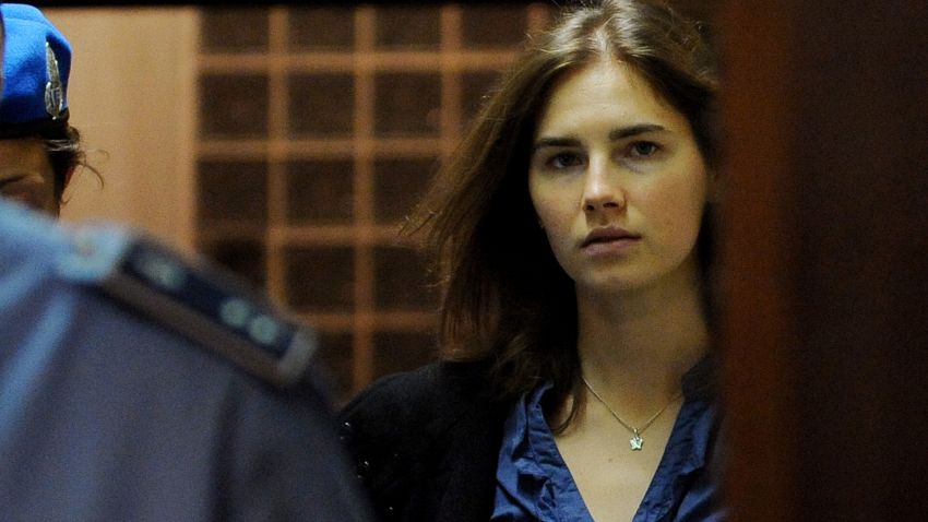 Amanda Knox (R), US national accused of the 2007 murder of her housemate Meredith Kercher arrives at the court during the resumption of her appeal trial in Perugia on September 30, 2011.