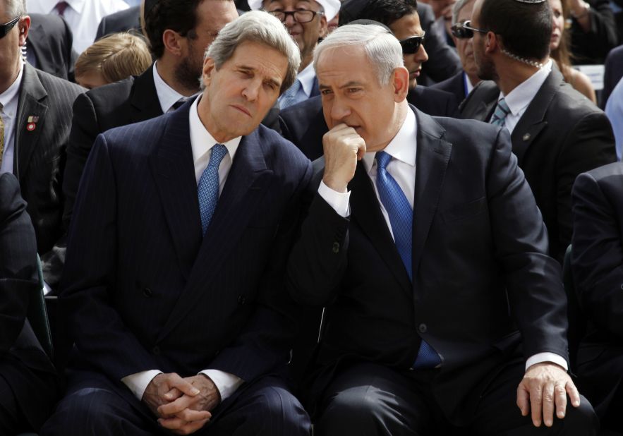 Israeli Prime Minister Benjamin Netanyahu, right, speaks with U.S. Secretary of State John Kerry during the annual ceremony for the Holocaust Remembrance day at the Yad Vashem memorial on April 8, 2013, in Jerusalem.