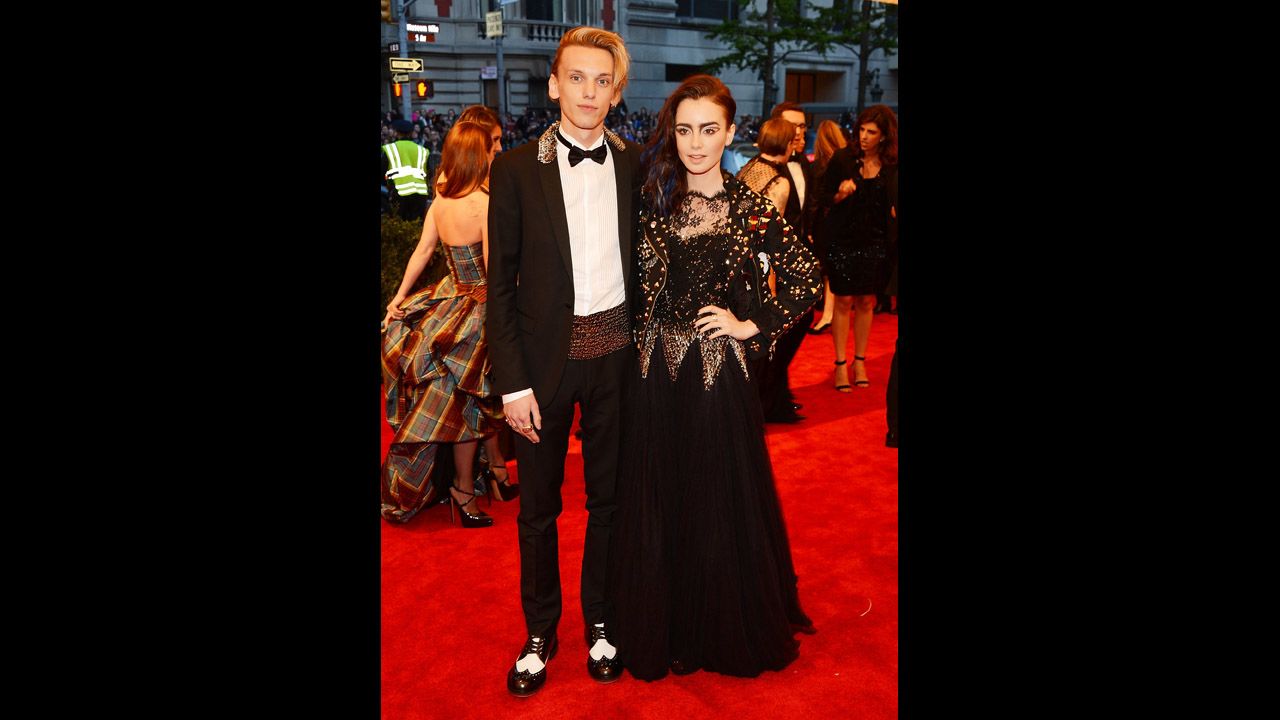 Jamie Campbell Bower and Lily Collins attend the gala.