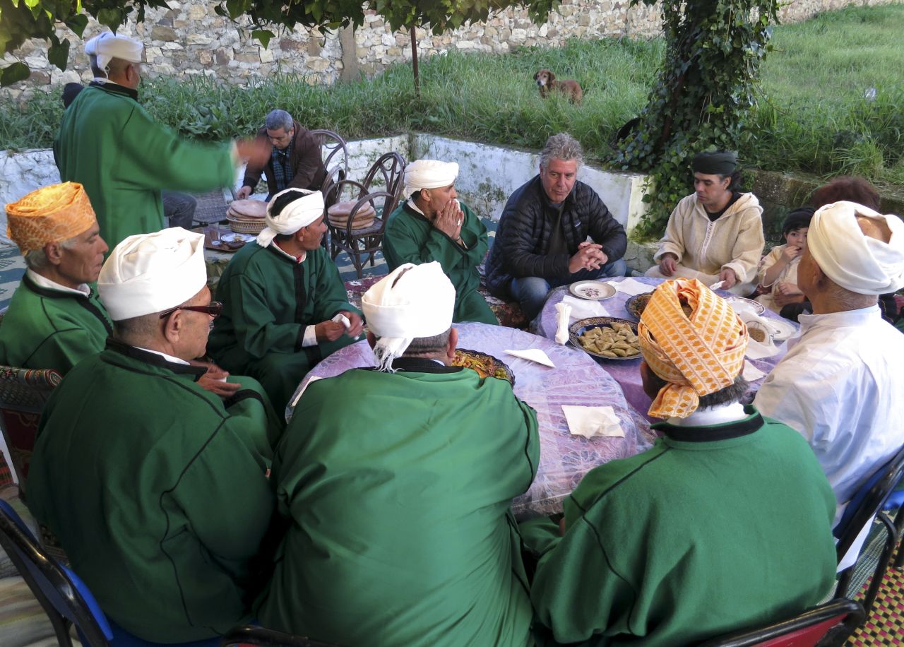 Bourdain shares a meal with Bachir Attar and the Master Musicians of Jajouka at Attar's home in the Moroccan village of Jajouka.