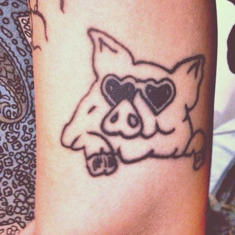 Rachael Sauceda's ink tribute to her mom is probably the most unconventional of the bunch. Her mother grew up on a pig farm, and Sauceda used to have a shirt with this design as a kid. It's now tattooed on her upper arm. She and both her brothers have <a href="http://ireport.cnn.com/docs/DOC-968610">matching pig tattoos</a> in honor of their mom. "She cringes every time we show up with another tattoo," says Sauceda, who has 14, "but she has confessed that she does like this one."
