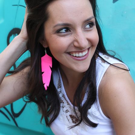 Morin models <a href="http://www.brit.co/flirty-fluorescent-feathers-another-win-for-duct-tape/" target="_blank" target="_blank">fluorescent feather earrings</a> made with neon duct tape.