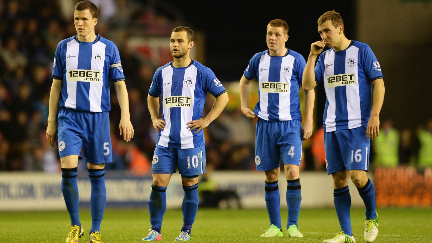 Wigan's players stand dejected after conceding against Swansea in a game they lost 3-2
