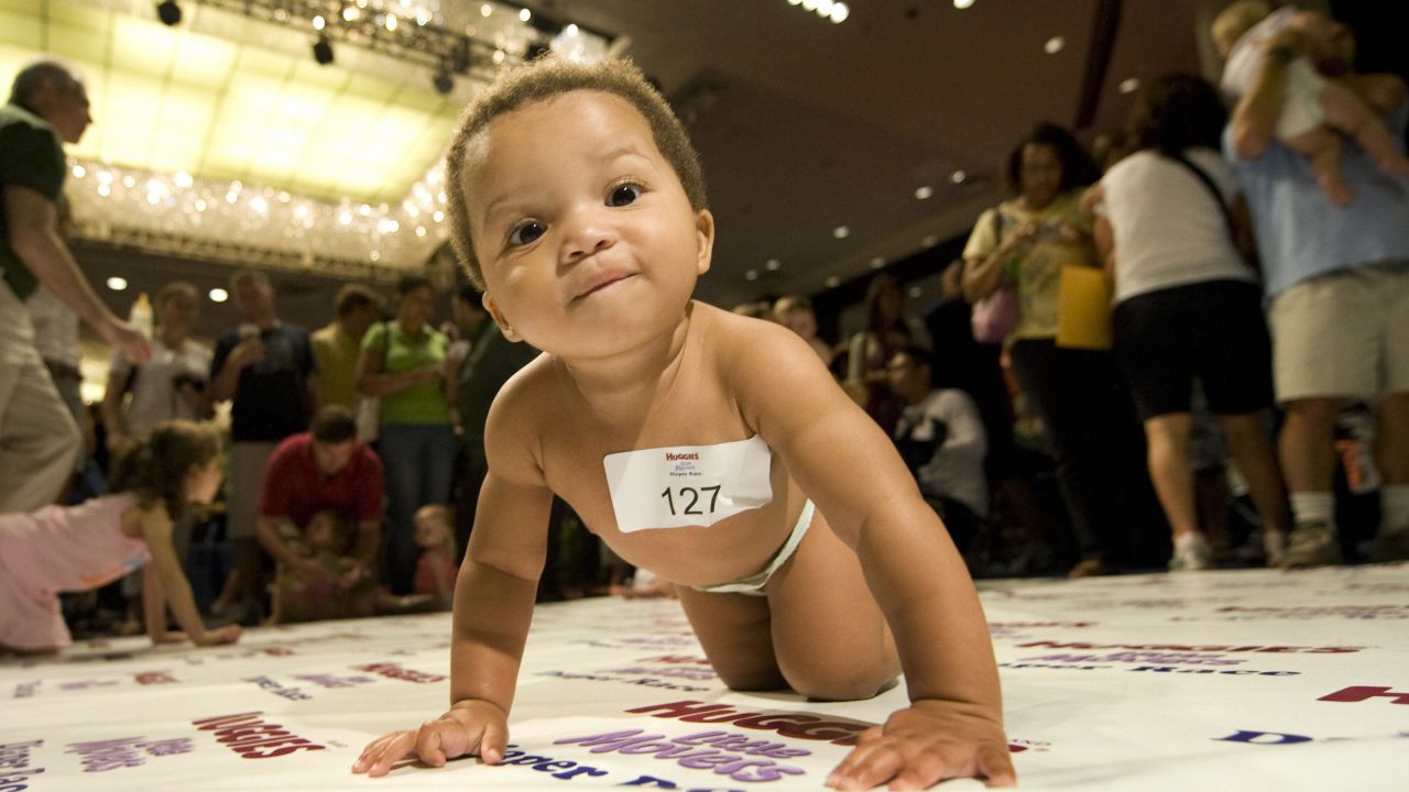 A diaper-clad baby crawls across a 10-foot mat during a baby race in New York. The first prize was a year's supply of diapers.
