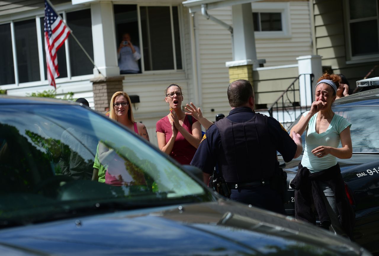 Friends and neighbors cheer as a car carrying Amanda Berry arrives at her sister's house in Cleveland on May 8.