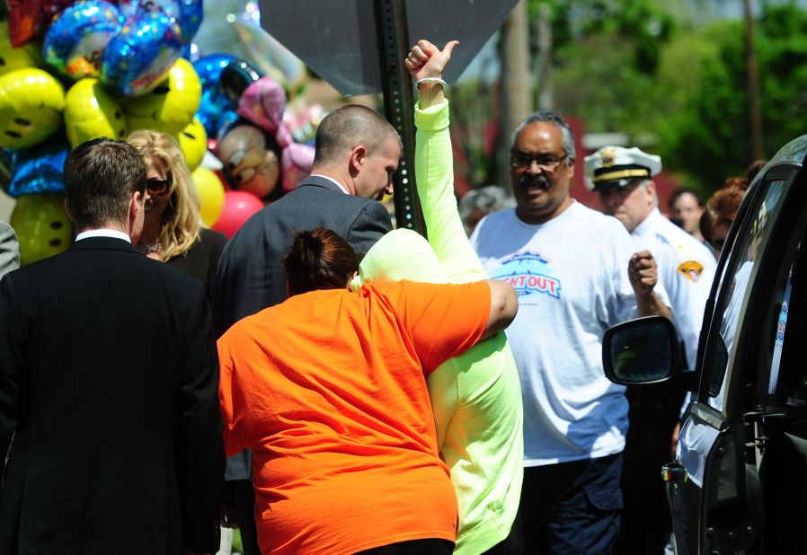 Gina DeJesus gives a thumbs up as she arrives at her family's house in Cleveland on May 8.