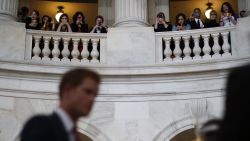 Capitol Hill staff take pictures of Prince Harry from the balcony of the Russell Senate Office Building on May 9.