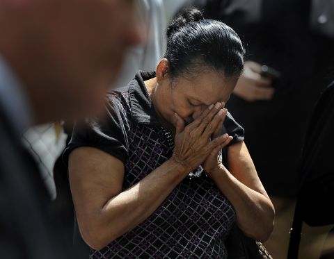 Ada Colon prays during a vigil held in honor of the kidnapping victims in Cleveland on Wednesday, May 8.
