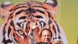 Former Pakistani Prime Minister Nawaz Sharif (C) waves as he addresses his supporters during an election campaign meeting in Islamabad on May 5, 2013. A roadside bomb exploded at an election rally in southwest Pakistan on May 5 killing two people, officials said as violence continued ahead of historic polls on Saturday. Campaigning has been marred by Taliban threats and attacks, which have killed 69 people since April 11, according to an AFP tally. Pakistan will elect its new government for the next five years in polls on May 11. The election of the national and four provincial assemblies will mark the first time a civilian government has completed a full term and handed over to another, in a country that has been ruled by the military for half its existence. AFP PHOTO / AAMIR QURESHI