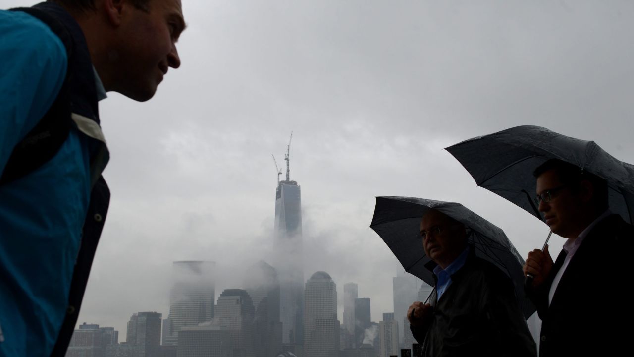 Rain doesn't deter an outing in Jersey City, New Jersey, and even a view of Lower Manhattan despite the fog on Thursday, May 9.