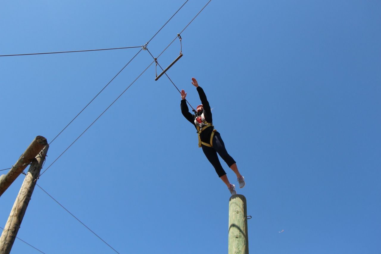 Campers participate in the "leap of faith," springing from a 35-foot pole onto a trapeze.