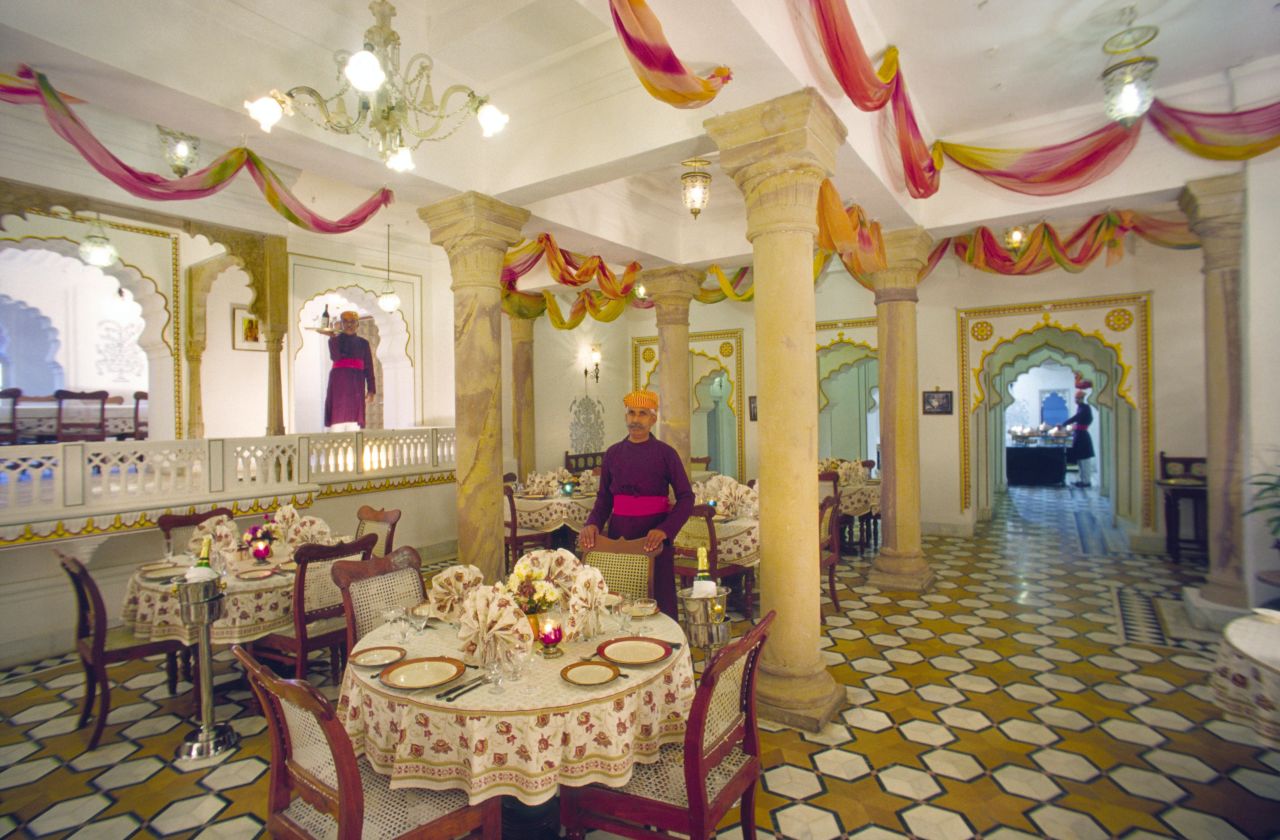 <strong>Deogarh Mahal, Deogarh: </strong>Waiters in traditional attire stand poised in the dining room of the Deogarh Mahal hotel.