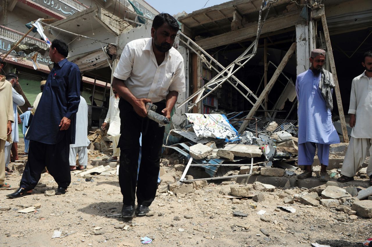 A bomb disposal expert examines the site of a detonation in Karachi, Pakistan on May 11.  