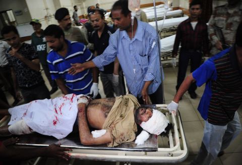 Men move a stretcher carrying an injured man at a hospital, following a bomb explosion in Karachi, Pakistan on May 11.