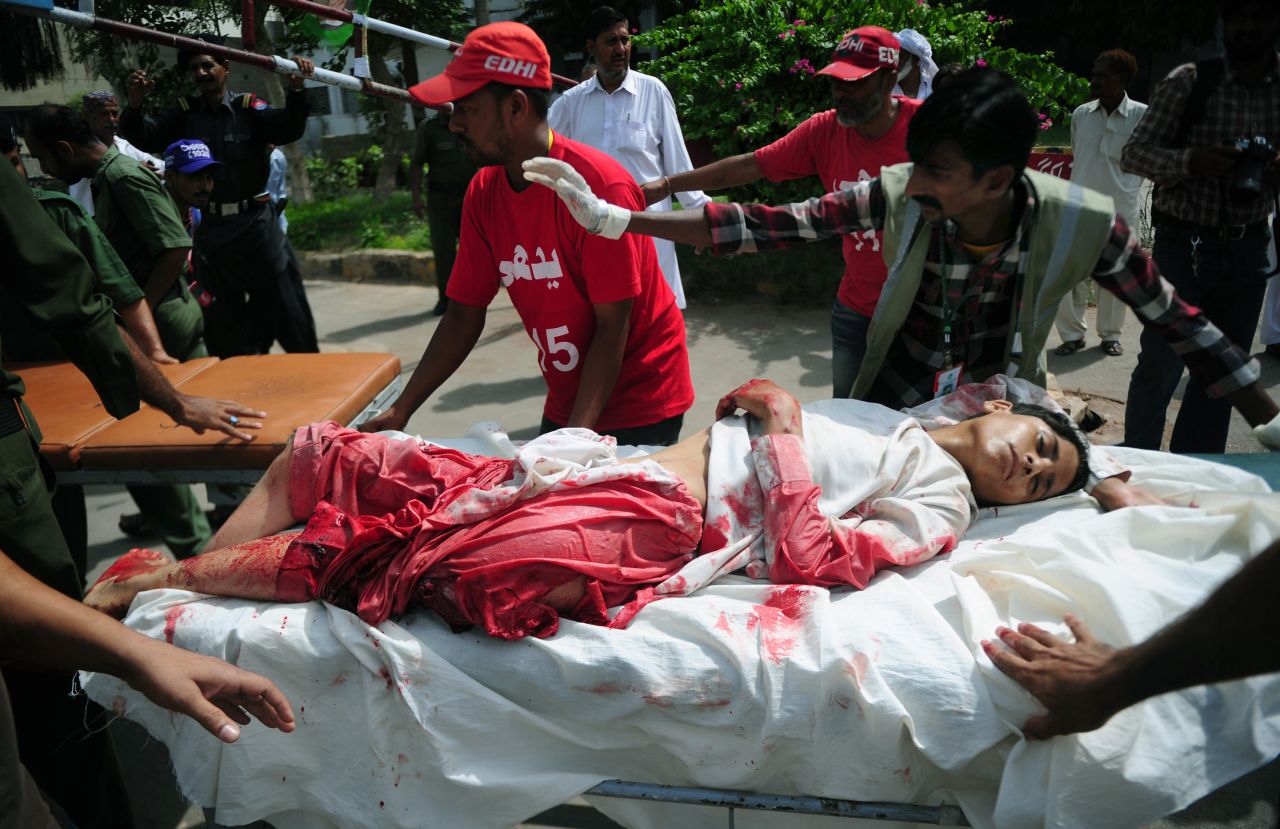 Volunteers move an injured boy to a hospital following a bomb explosion in Karachi on May 11.