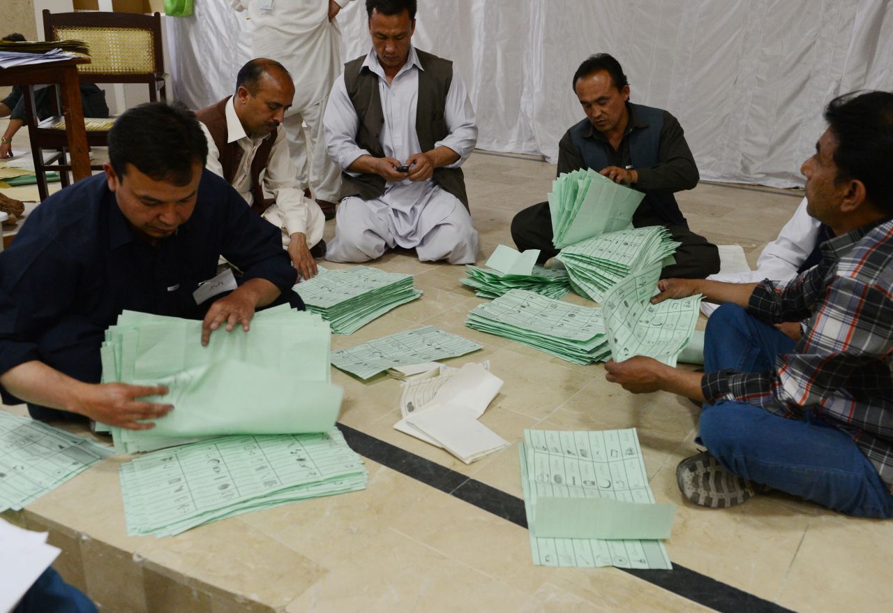 Election officials count ballot papers at the end of polling in Quetta, Pakistan on May 11.