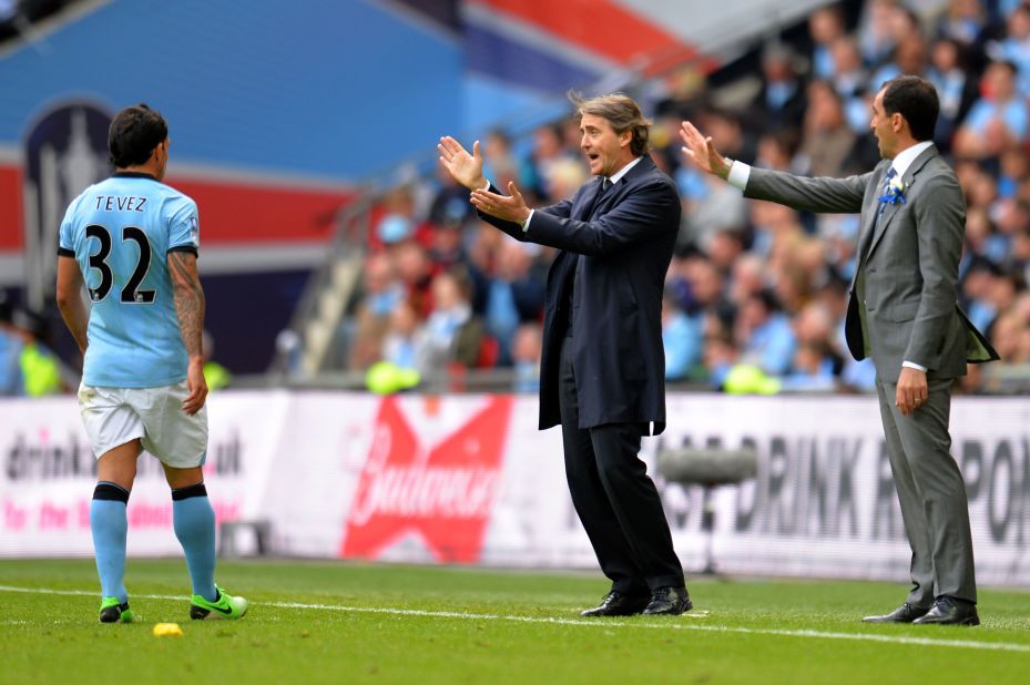 Speculation has been rife that the clubs' respective managers will be elsewhere next season. Reports claim City's Roberto Mancini, center, will be replaced by Malaga's Manuel Pellegrini, while Martinez has been linked with a move to Everton.