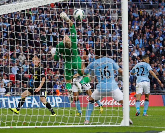Wigan's winner came in time added on from substitute midfielder Ben Watson, left, who headed past City's England goalkeeper Joe Hart. Watson missed almost six months this season with a broken leg.
