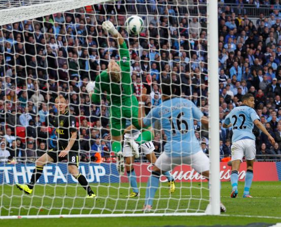 Wigan's winner came in time added on from substitute midfielder Ben Watson, left, who headed past City's England goalkeeper Joe Hart. Watson missed almost six months this season with a broken leg. 