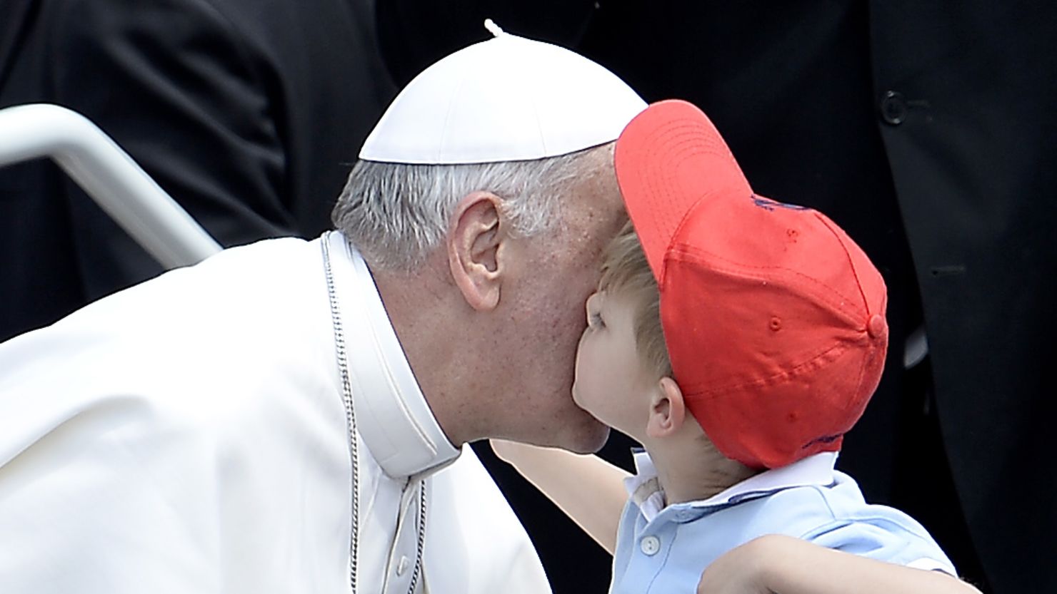 Pope Francis is kissed by a boy on Sunday in St.Peter's Square at the end of a canonization service.