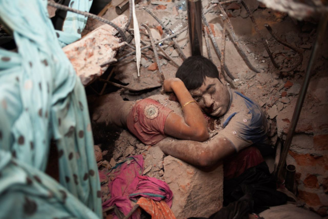 Two bodies clutch each other in the rubble on Thursday, April 25.