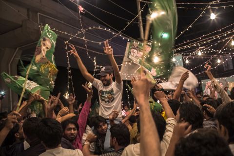 Supporters of Pakistan Muslim League Nawaz, Nawaz Sharif's party, celebrate election results in front of a party office in Lahore on election night, Saturday, May 11.