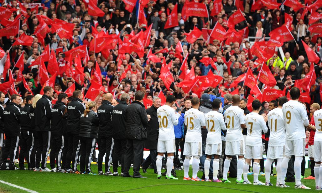 Ferguson walked onto the pitch at Old Trafford through a guard of honor formed by the United and Swansea City players.