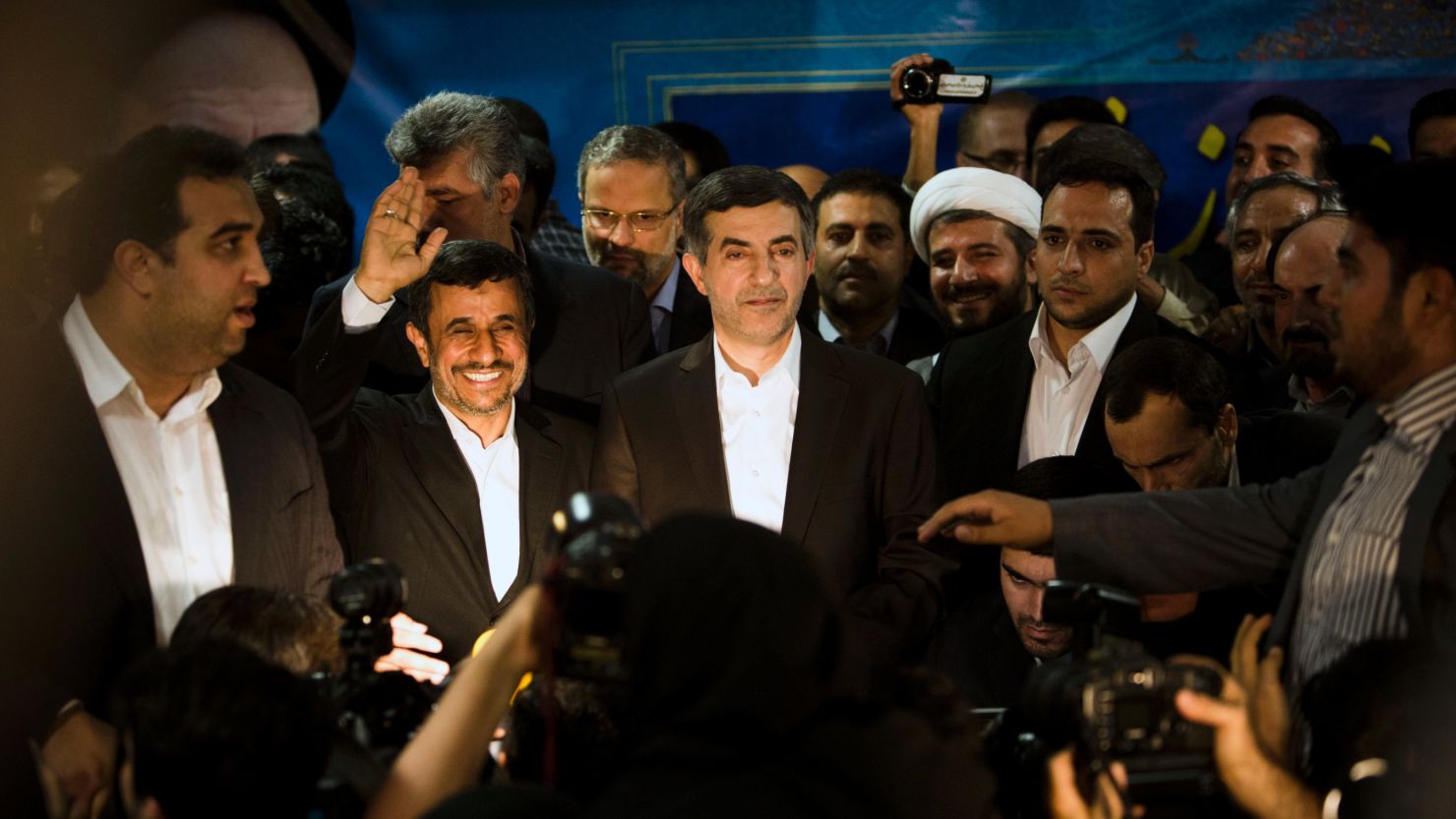 Iranian President Mahmoud Ahmadinejad accompanies Esfandiar Rahim Mashaie, center,  to register his candidacy.