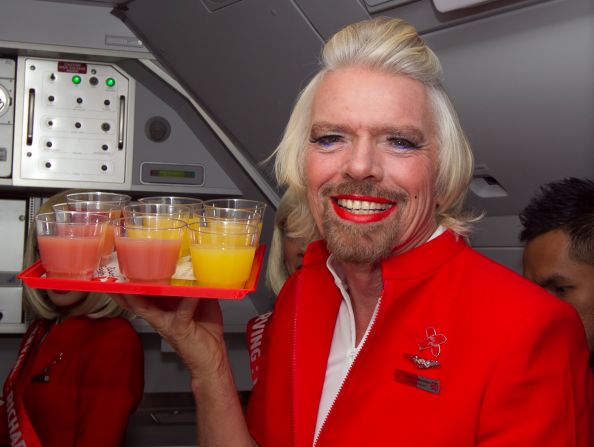 Sir Richard Branson worked as an AirAsia X flight attendant on Sunday after losing a bet to AirAsia CEO Tony Fernandes.