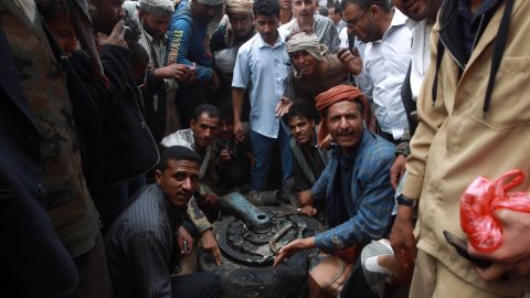 Yemenis surround one of the tyres of a Russian-made Yemeni military jet after it crashed in the capital Sanaa on May 13.