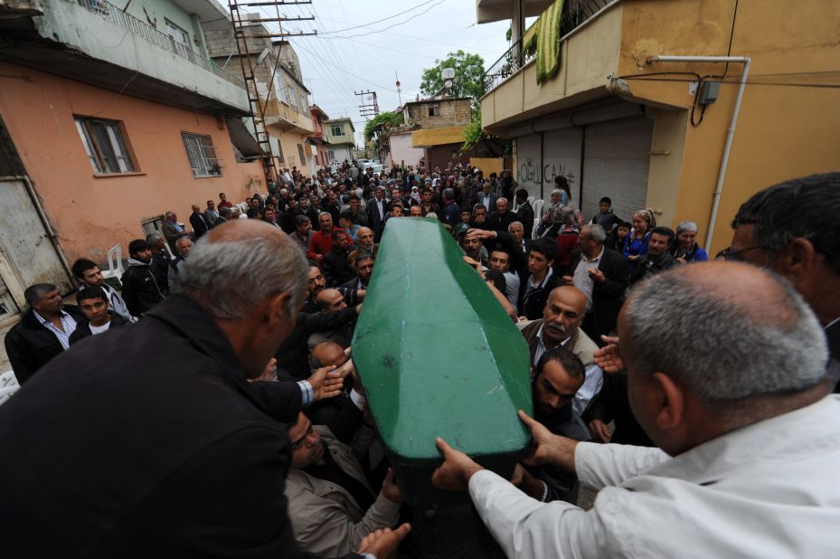 The body of Ogulcan Tuna, 18, is carried during the May 12 funeral for the bombing victims.