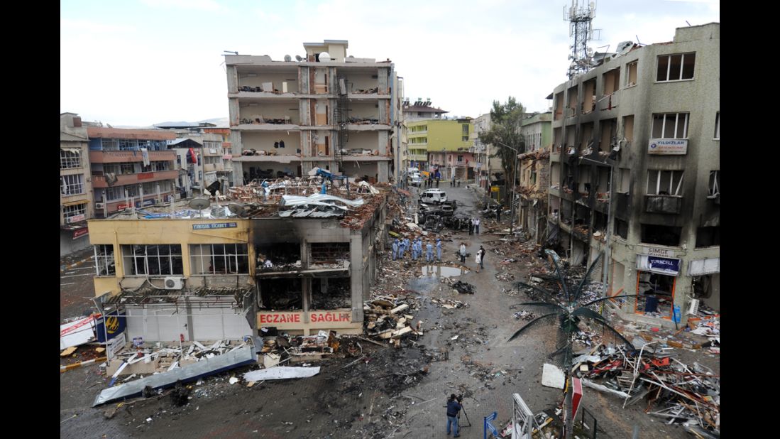 Police investigate the Reyhanli neighborhood on May 12 where buildings collapsed, glass shattered and fire scorched the street and injured bystanders after the bombings the day before.