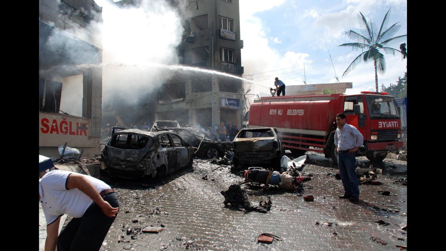 Emergency crews work to put out a fire near the town hall in Reyhanli after a car bomb exploded Saturday, May 11, 2013.
