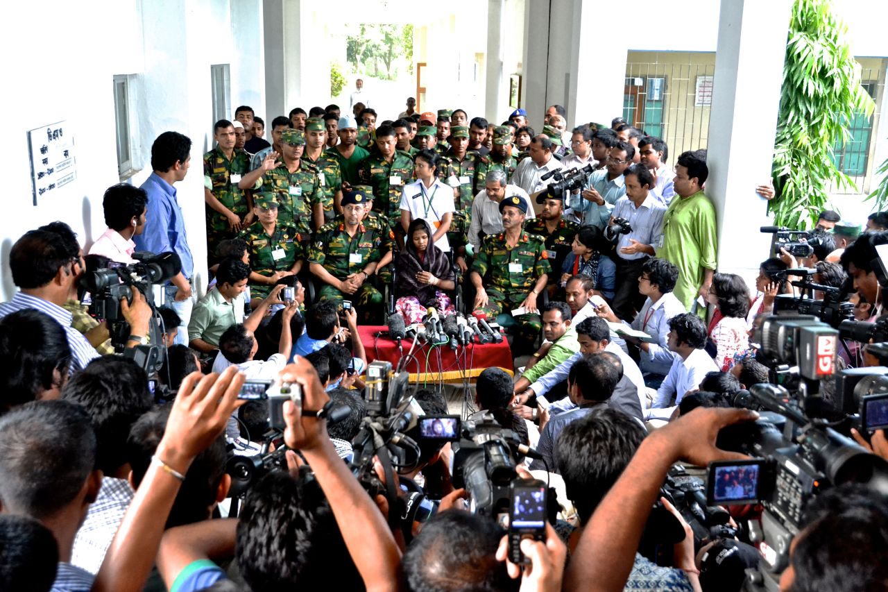 Throngs of reporters crowd around Begum as she speaks publicly for the first time on May 13 about her ordeal in Dhaka.