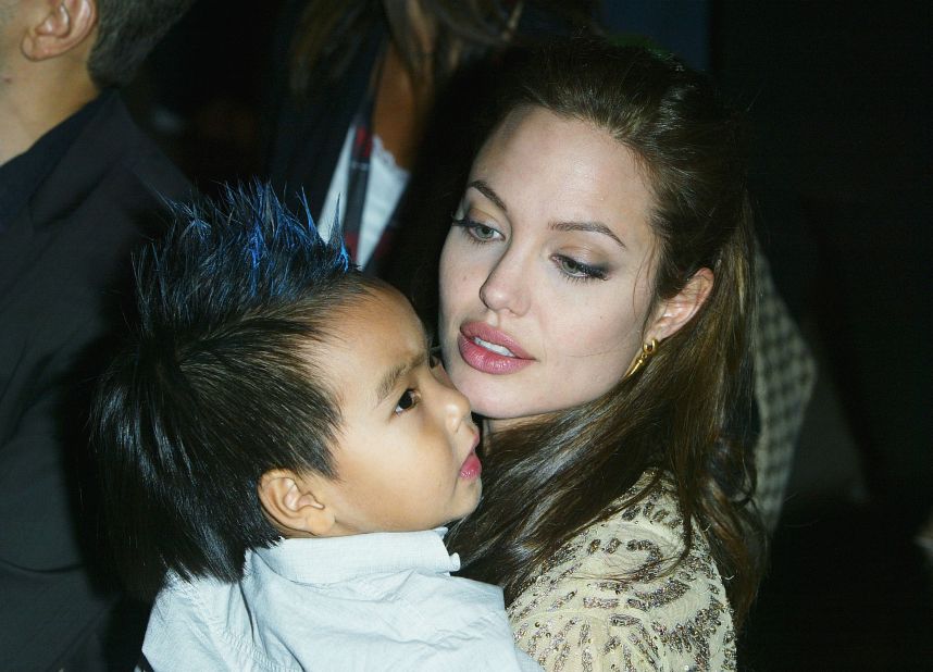 Jolie carries her son Maddox at the world premiere of "Shark Tale" in September 2004. 