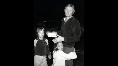 Jolie hugs her father, actor Jon Voight, in Los Angeles in 1980. Her brother, James, is at left.