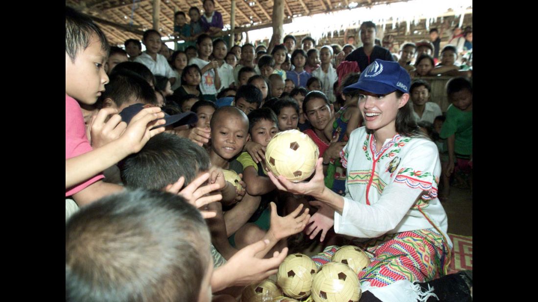 Jolie distributes balls to children at the Tham Hin refugee camp, on the Thailand-Myanmar border, in May 2002. She was a goodwill ambassador for the United Nations High Commissioner for Refugees before she became a special envoy for the agency in 2012.